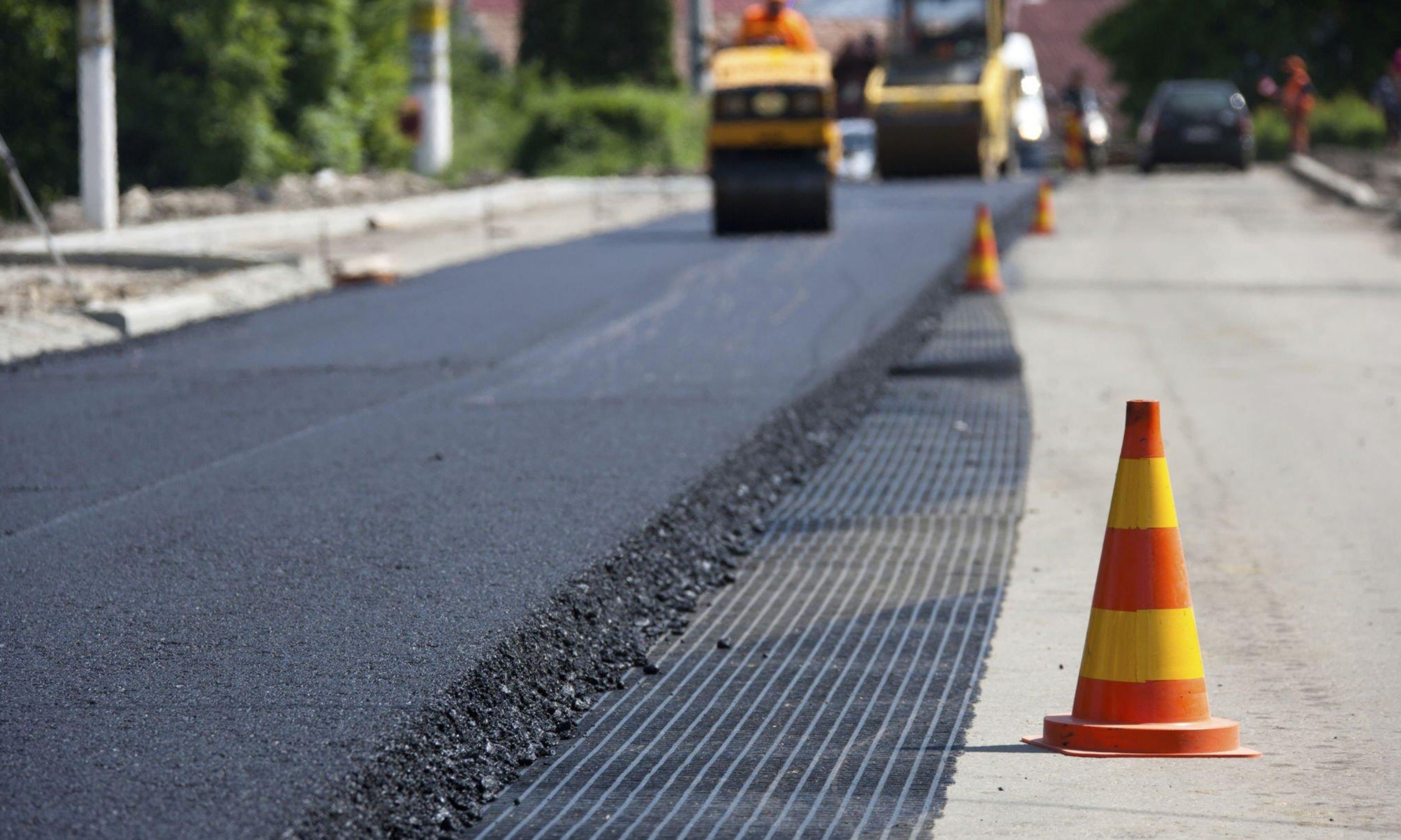 Newly laid asphalt road with safety cones